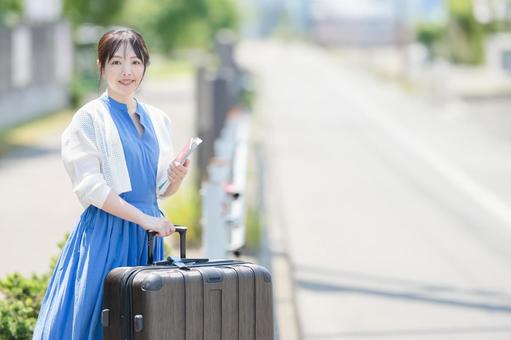 スーツケースを引いてホームを歩く一人旅の女性 11038008287 の写真・イラスト素材アマナイメージズ